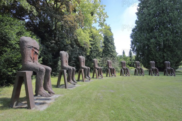 Sculpture Seated Figures by Magdalena Abakanowicz 2010, art installation, modern art, abstract art, steel sculpture, rusty, row of chairs, chairs, row, series, circle, 9 seated figures, torso, without, none, none, missing, head, synchronous, Gustavsgarten, Bad Homburg, Taunus, Hesse, Germany