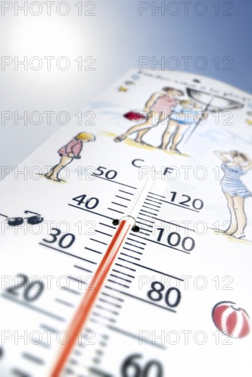 Worm's-eye view of thermometer measures extremely hot temperature of 40 degrees Celsius, 40 °C, 100 °F during heatwave, heat wave in summer