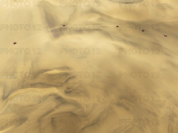 Quad bikes in the dunes of the Namib Desert in the vicinity of the coastal town of Swakopmund. Aerial view. Drone shot. Namibia