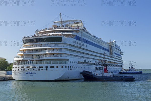 Cruise ship AIDA nova is pushed against the quay wall by tugboats, Warnow, Warnemünde, Rostock, Mecklenburg-Western Pomerania, Germany