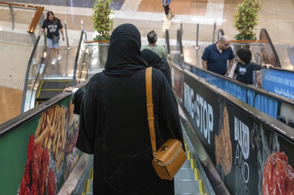 Veiled woman with handbag, Abu Dhabi, United Arab Emirates