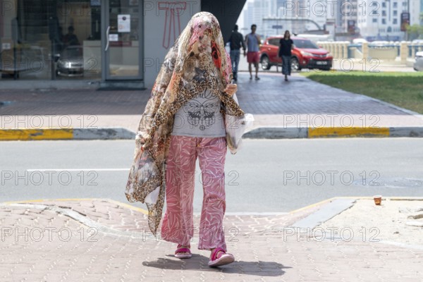 Woman fashionably veiled, Abu Dhabi, United Arab Emirates