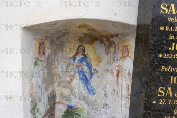 Damaged religious fresco on a wall niche with figures, Zgornje Jezersko, Gorenjska, Slovenia