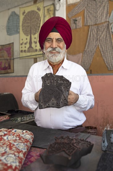 Indian Sikh, 68 years old, showing a wooden panel for woodblock printing, Jaipur, Rajasthan, India