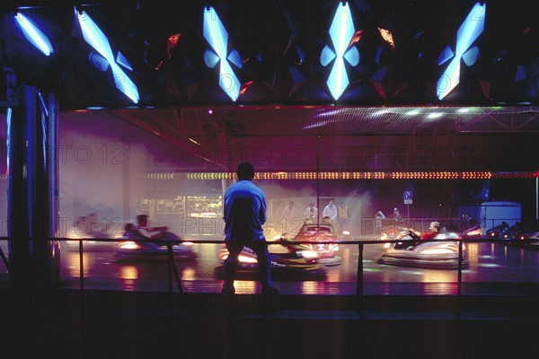 Illuminated bumper cars at night, New Jersey, USA