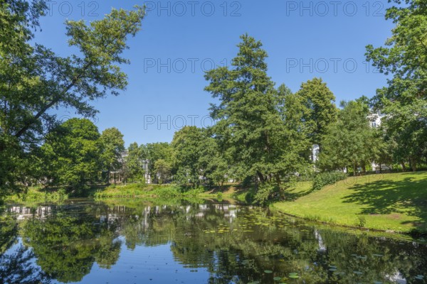 View across the water to Contresarpe Street, Bremen ramparts, formerly part of the city fortifications with ramparts and moat, today a park, water reflection, nature experience, history, Bremen, Germany