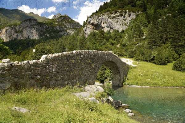 The Romanesque bridge Puente Románico de San Nicolás de Bujaruelo over the River Ara in the Bujaruelo Valley or Valle de Bujaruelo near Torla-Ordesa, Spain