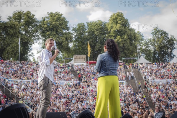 Sebastian Oswald and Simone Panteleit, presenters at the Berliner Rundfunk 91.4 Open Air at the Berlin Parkbühne Wuhlheide on 5 July 2025