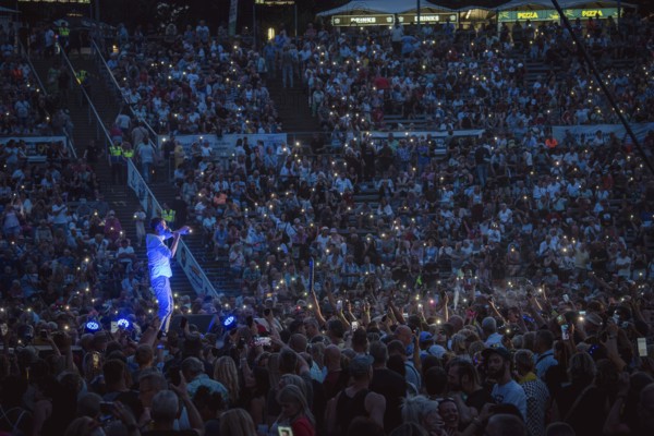 Sea of lights with Sebastian Oswald, one of the presenters at the Berliner Rundfunk 91.4 Open Air in Berlin's Parkbühne Wuhlheide on 5 July 2025