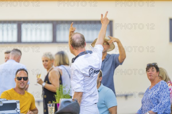 People enjoying themselves outdoors at a social event with a summery atmosphere, 950 years Weil der Stadt ceremony, Böblingen district, Germany