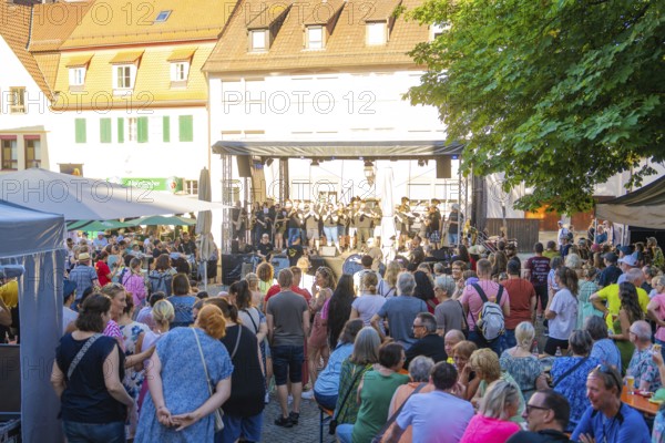 A large crowd gathers around a stage during a concert at a town festival, 950 years Weil der Stadt ceremony, Böblingen district, Germany