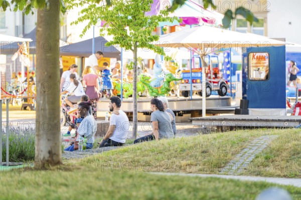 People enjoying a sunny day in the park with activities and carousel, 950 years Weil der Stadt ceremony, Böblingen district, Germany