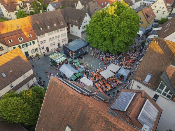 Aerial view of a lively town festival, surrounded by orange-coloured roofs and green trees in summer, 950th anniversary of Weil der Stadt, Böblingen district, Germany