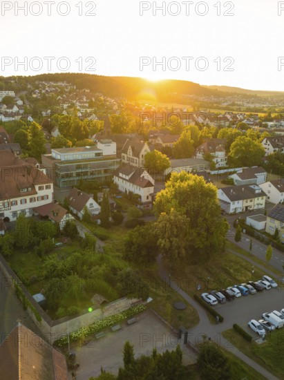 Landscape with a village car park at sunset, surrounded by trees and a quiet atmosphere, 950 years Weil der Stadt ceremony, Böblingen district, Germany