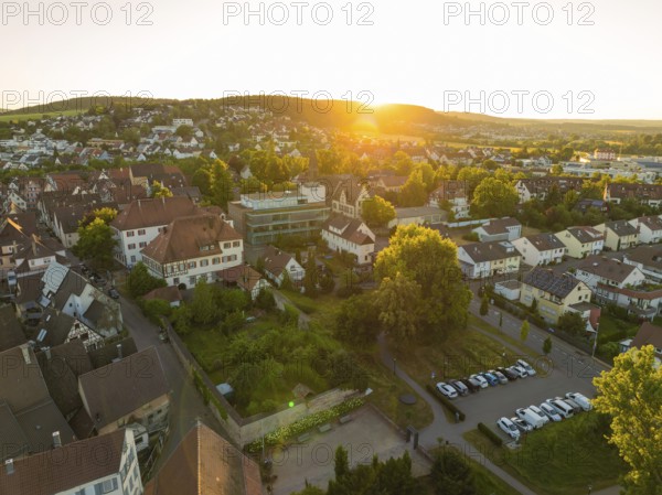 Sunset over a village with car parks, surrounded by lush nature and peaceful countryside, 950 years Weil der Stadt ceremony, Böblingen district, Germany