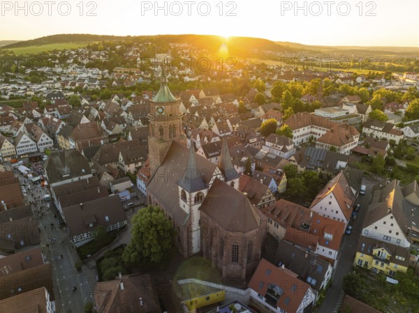 Aerial view of a church surrounded by an idyllic cityscape at sunset, 950 years Weil der Stadt ceremony, Böblingen district, Germany