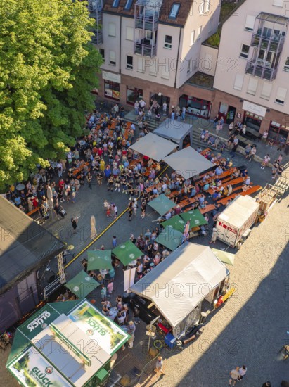 Aerial view of a town festival with numerous people and tents on a town square in sunny weather, 950 years Weil der Stadt ceremony, Böblingen district, Germany