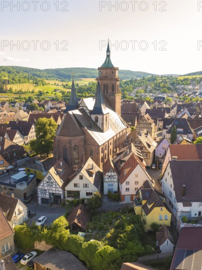 Large church building surrounded by traditional half-timbered houses in a rural setting, 950th anniversary of Weil der Stadt ceremony, Böblingen district, Germany