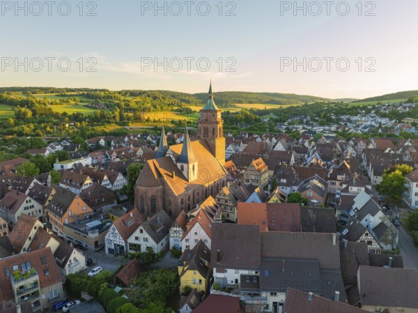 A picturesque village with a church under warm evening light in a hilly landscape, 950 years Weil der Stadt ceremony, Böblingen district, Germany