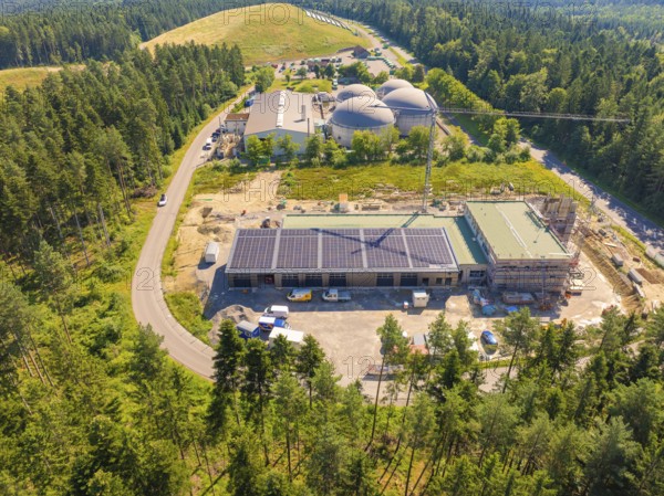 Construction work in a rural setting with solar energy on the roofs and surrounded by forest, new fire station, Oberhaugstett, Calw district, Germany