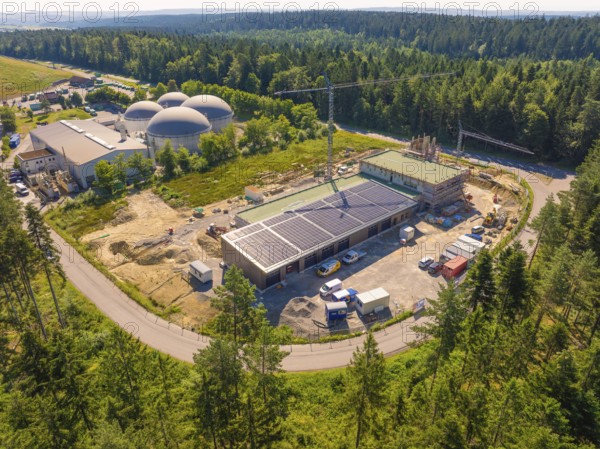 Embedded in a forest landscape, the picture shows solar systems on buildings at a construction site, new fire station, Oberhaugstett, Calw district, Germany