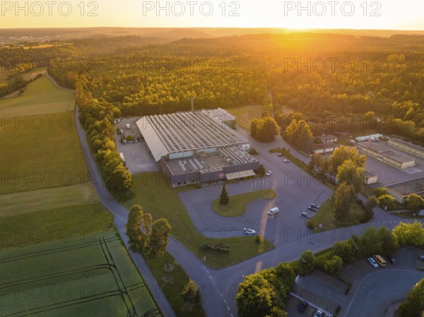 Industrial area at sunset, surrounded by nature and roads, Sektkellerei Schnaufer, Althengstett Calw