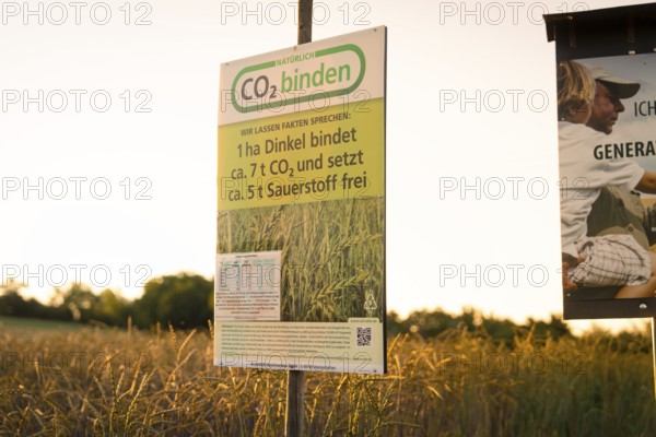 Sign on a field at sunset emphasises CO2 sequestration and sustainability
