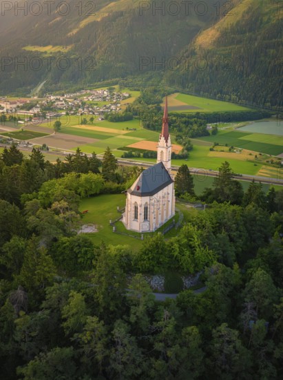 Sublime church on a hill overlooking a valley in the warm evening light