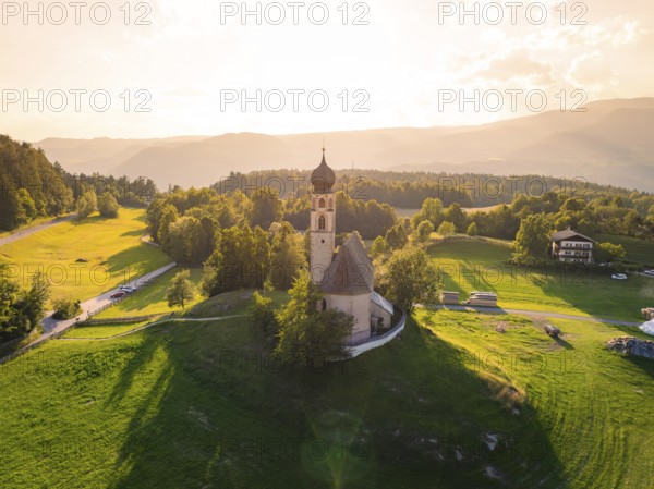 Church in a clearing with a view of the surrounding area at sunset in a tranquil setting