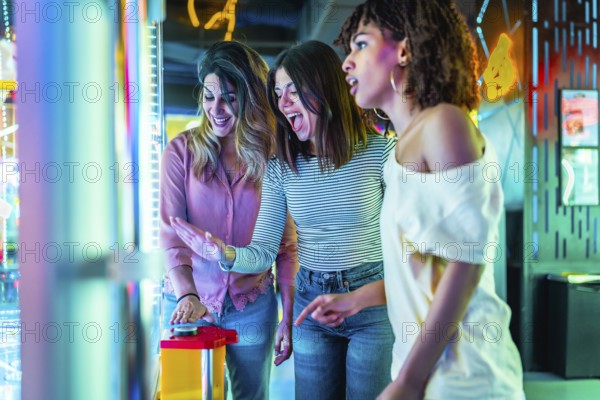 Three young women enjoying their time together at an amusement arcade, playing games and having fun in a vibrant, colorful atmosphere
