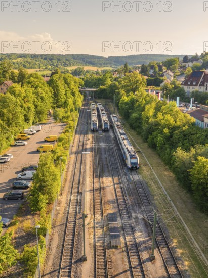 Top view of trains and tracks amidst trees and a residential area, summer, Weil der Stadt railway station, Böblingen district, Germany