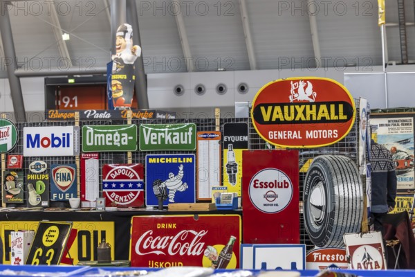 Historic enamel signs, collection of Vauxhall, Coca-Cola, Esso, Michelin and other brands from the automotive industry. Sales stand at the Retro Classics classic car trade fair in Stuttgart, Baden-Württemberg, Germany