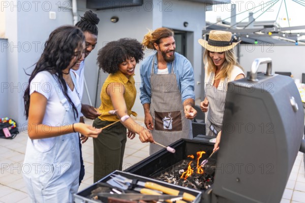 Happy friends enjoying a rooftop party, roasting marshmallows over a barbecue grill while sharing laughter and creating lasting memories