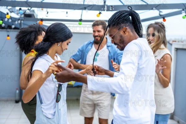 Young people dancing joyfully at a vibrant rooftop party, soaking in the summertime atmosphere and celebrating together under the evening lights