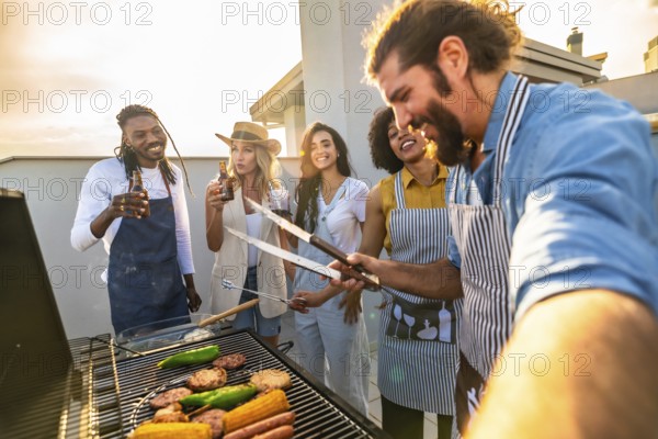 Chefs grilling food and taking a selfie on a rooftop at sunset, enjoying a barbecue party with drinks