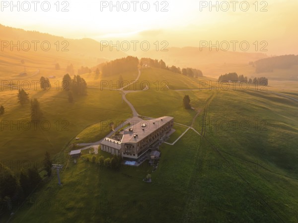 Architectural building on a hill with evening light and peaceful atmosphere, Alpe di Siusi, Dolomites, South Tyrol, Italy