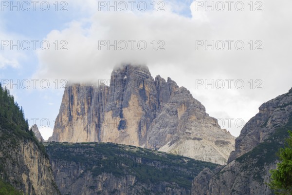 Majestic Dolomites covered by clouds under a blue cloudy sky, Dolomites, South Tyrol, Italy