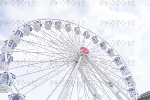 Modern Ferris wheel with gondolas in front of a slightly cloudy sky, Ferris wheel construction, Calw, Germany