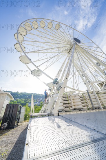 View of a large Ferris wheel under a blue sky, modern construction, construction of Ferris wheel, Calw, Black Forest, Germany
