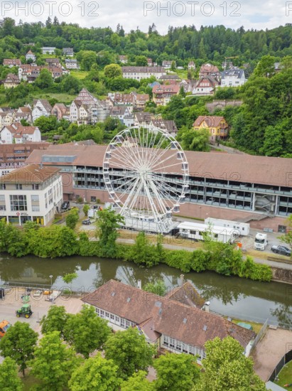 Ferris wheel next to modern and historic buildings in a green setting, Ferris wheel construction, Calw, Black Forest, Germany