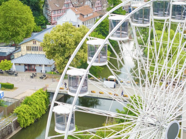 Ferris wheel overlooking a river and surrounding village landscape in the countryside, Ferris wheel construction, Calw, Black Forest, Germany