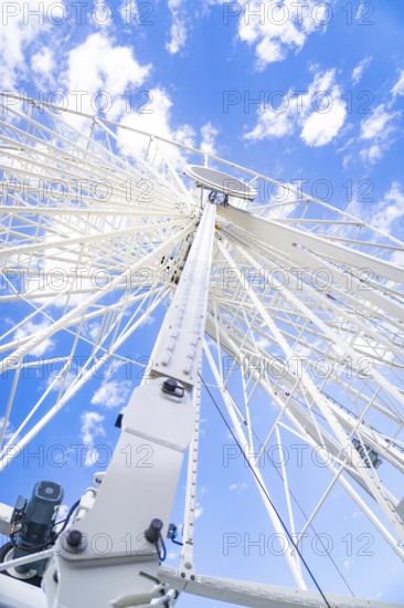 Close-up of a Ferris wheel with blue sky and clouds, Ferris wheel construction for the 950th anniversary of the town of Calw, Black Forest, Germany