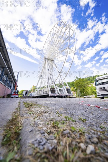 Ferris wheel under construction next to a white lorry under a blue, cloudy sky, Ferris wheel construction for the 950th anniversary of the town of Calw, Black Forest, Germany