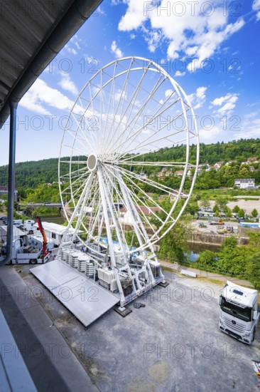 Construction phase of a Ferris wheel next to lorries in a rural setting, Ferris wheel construction for the 950th anniversary of the town of Calw, Black Forest, Germany