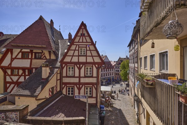 Historic half-timbered houses, residential buildings, gables, pointed roofs, façade, window, balcony, backlight, blue sky, cirrostratus clouds, Am Ölberg, Beim Tiergärtnertor, Obere Schmiedgasse, Nuremberg, Middle Franconia, independent city, Bavaria, Germany