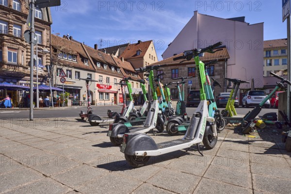 E-scooter in the city, problem, traffic problem, general architecture, pavement, pavement slabs, frog perspective, blue sky, cirrostratus clouds, intersection Grasersgasse with Dr.-Peter-Schönlein-Platz and Klaragasse, Nuremberg, Middle Franconia, independent city, Bavaria, Germany