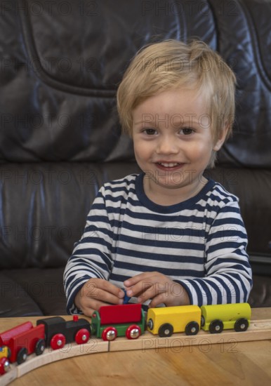 JBlond boy, 2 years old, playing with toy train in Ystad, Skåne County, Sweden, Scandinavia