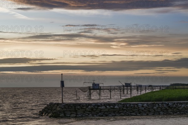 Sunset over Fishing huts over Gironde Estuary, Braud-et-Saint-Louis, France