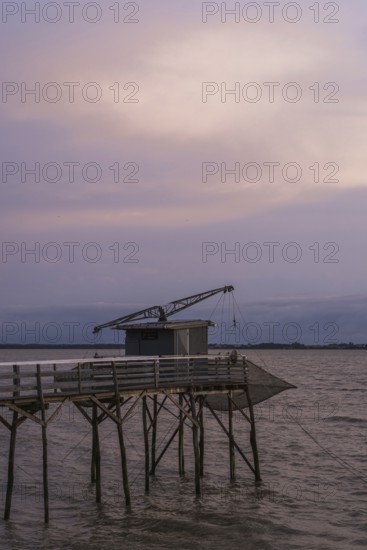 Sunset over Fishing huts over Gironde Estuary, Braud-et-Saint-Louis, France