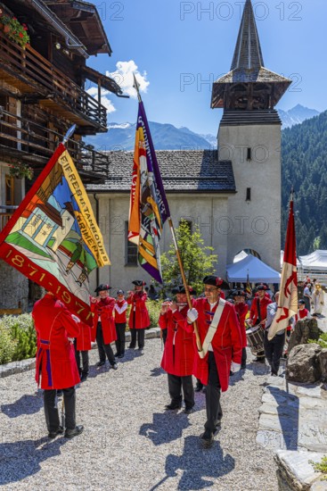 Pipers and drummers line up for the Corpus Christi procession, behind the church of Saint Theodul, historic town centre, Grimentz, Val d'Anniviers, Valais Alps, Canton Valais, Switzerland